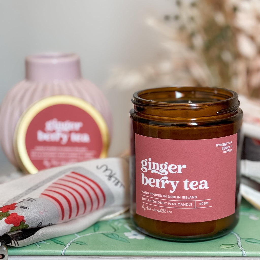 ginger berry tea lemongrass, ginger and berry scented hand pour candle in an amber jar