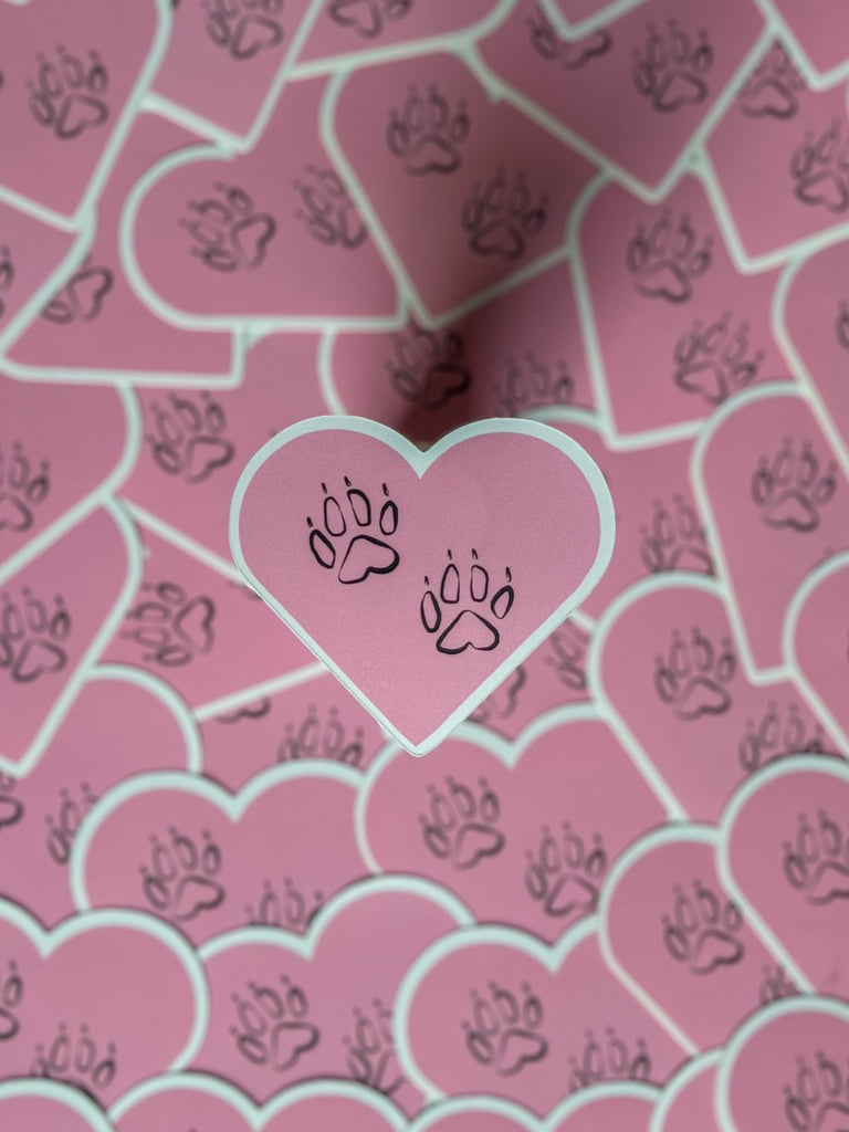 dog paws in a pink heart sticker
