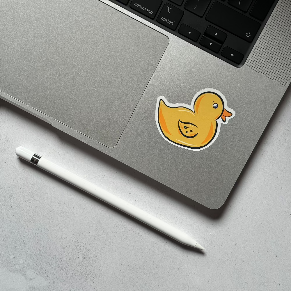 Close-up of a yellow rubber duck sticker on a laptop, adding a fun and quirky design to tech accessories