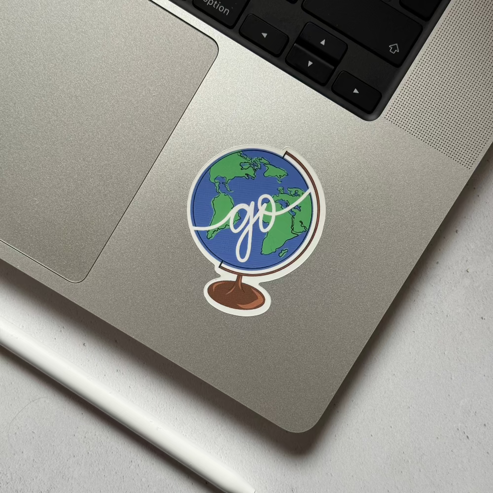 globe sticker that says go. perfect for a travel laptop