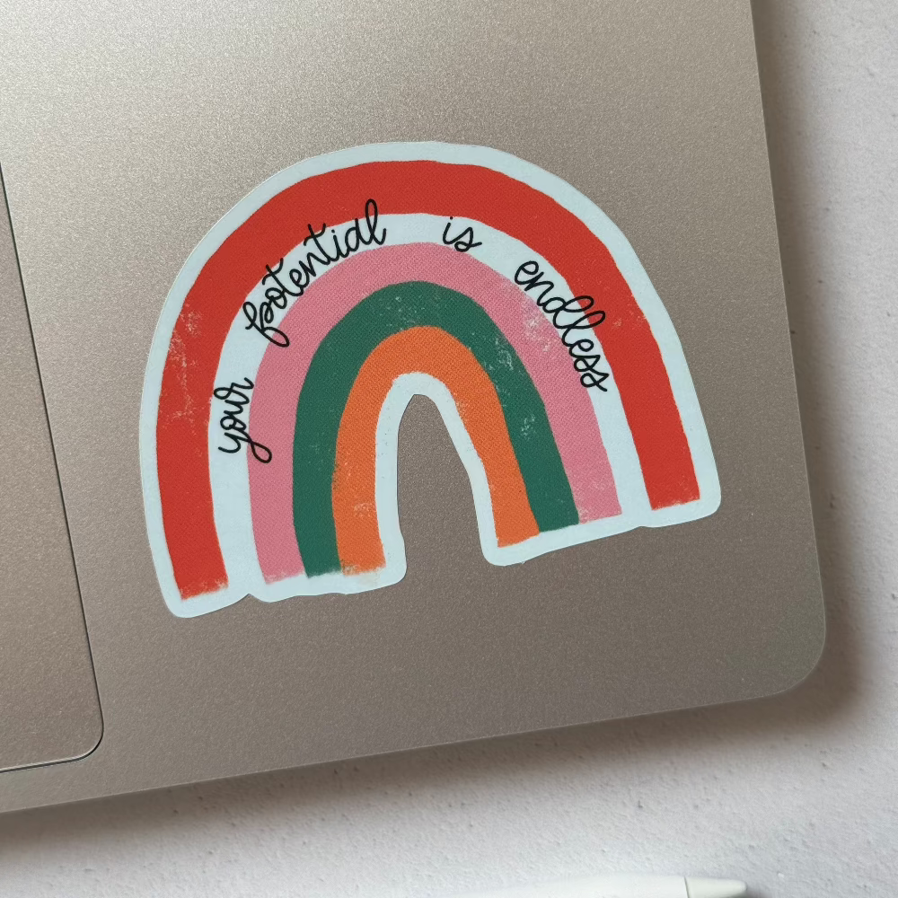 Rainbow 'Your Potential Is Endless' sticker on a laptop, adding a vibrant, motivational touch to your tech accessories