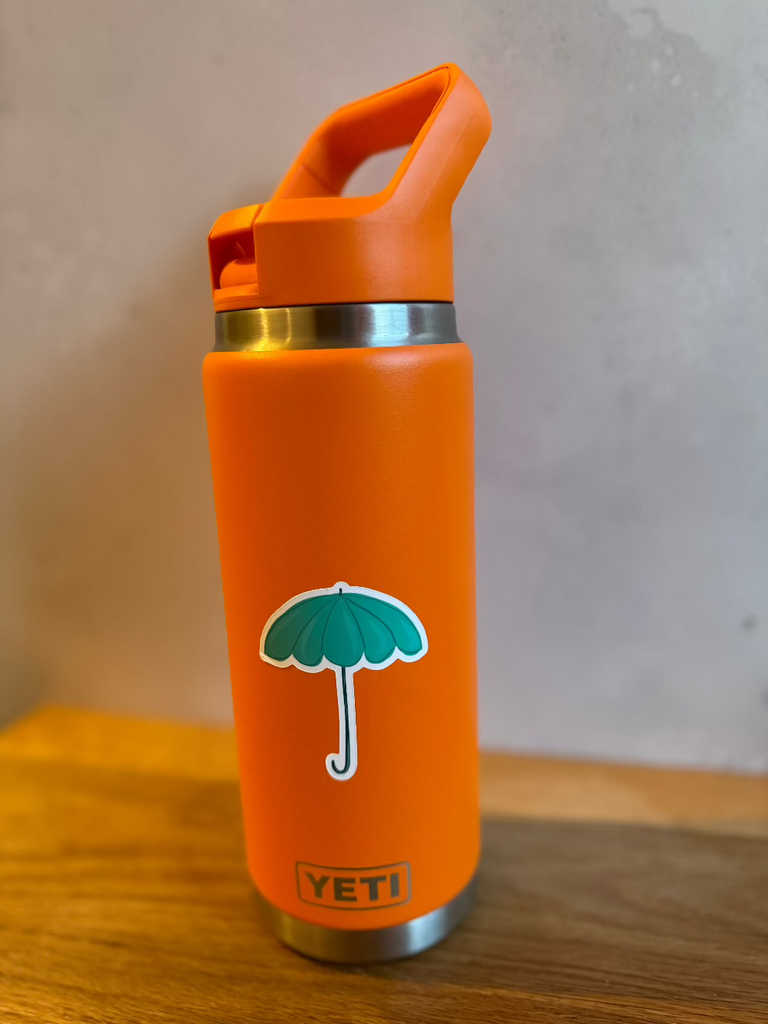 teal umbrella vinyl sticker on a water bottle
